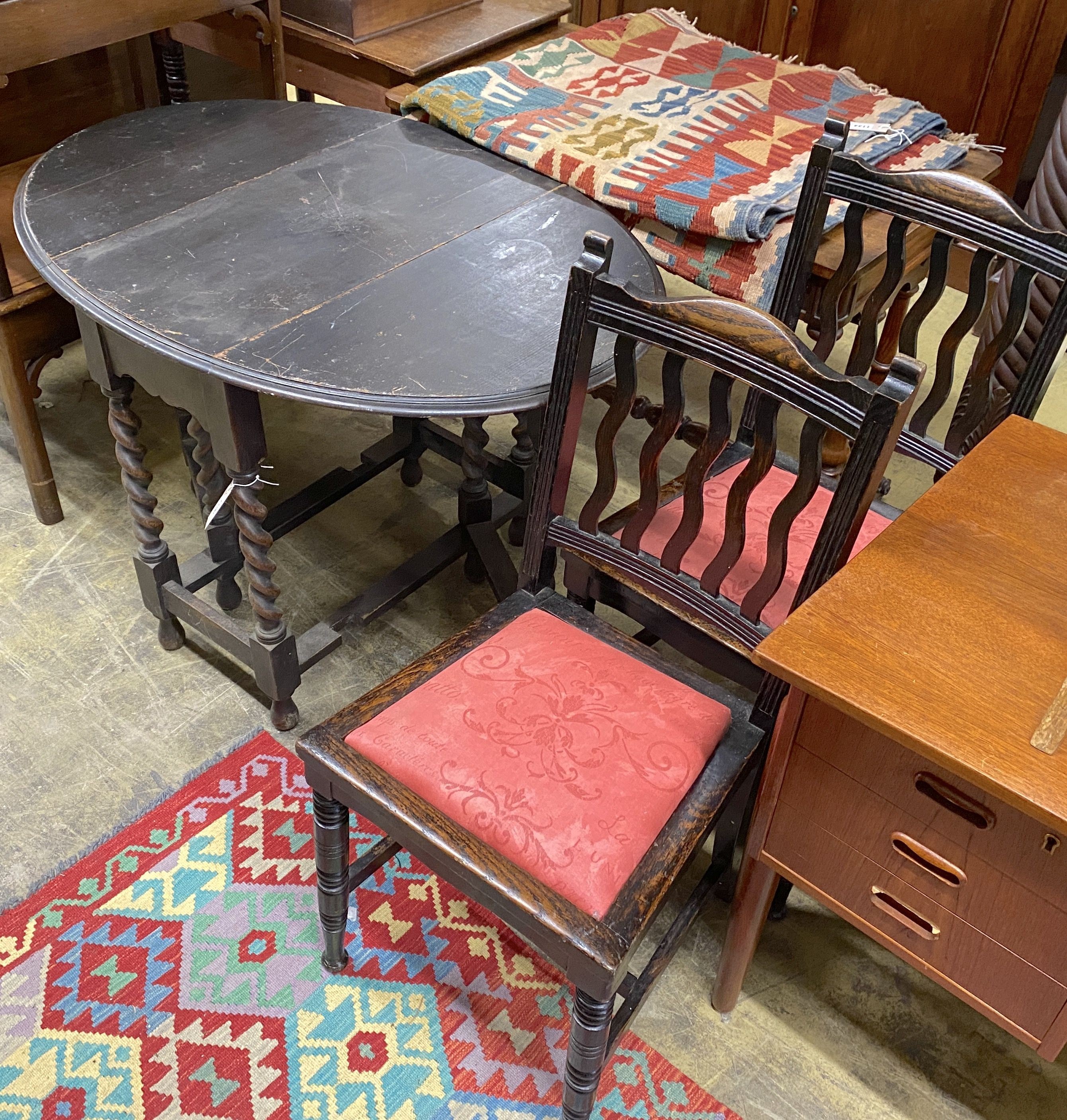 An early 20th century oak oval gateleg table, 106cm extended, width 74cm, height 74cm together with two oak dining chairs